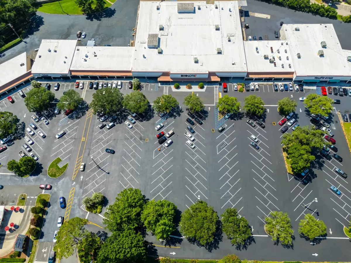 Standing Water in a Tallahassee Shopping Center Lot and What It Is Costing You